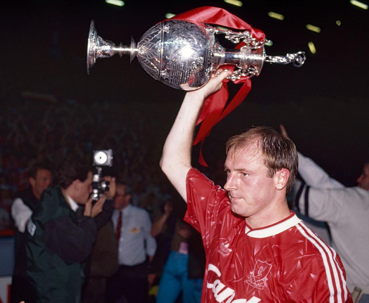 Steve McMahon of Liverpool celebrates with the League Championship trophy as Liverpool clinch the title following a 1-0 victory over Derby County at Anfield