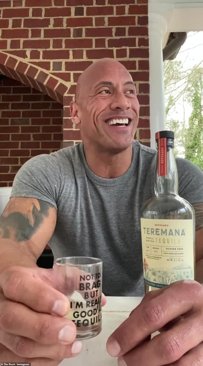 Dwayne Johnson takes a shot of alcohol and sings during the coronavirus quarantine in a photo uploaded to Instagram (pictured)