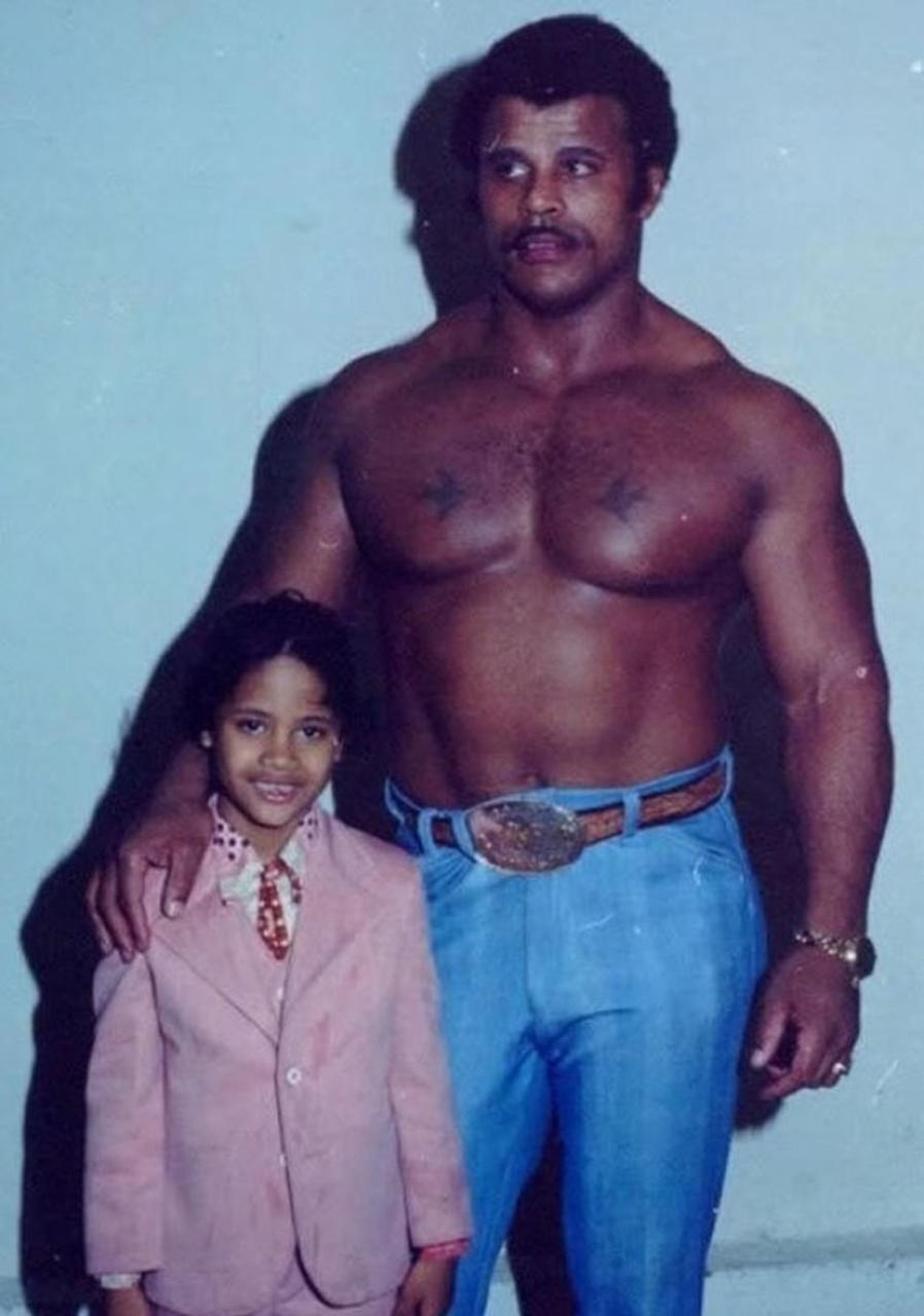 Dwayne's life took a turn for the better when he decided he wanted to follow in his father Rocky 'Soul Man' Johnson's footsteps - who had made history as a professional wrestler. Pictured, as a child with his dad