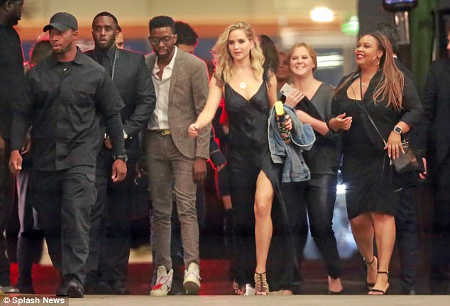 Glamorous: Flaunting her honed figure and a hint of cleavage, the dress sported a plunging neckline and button detail down the bust (above with pals P Diddy and Amy Schumer)