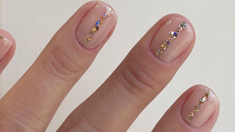 Nude nails with gold glitter polish